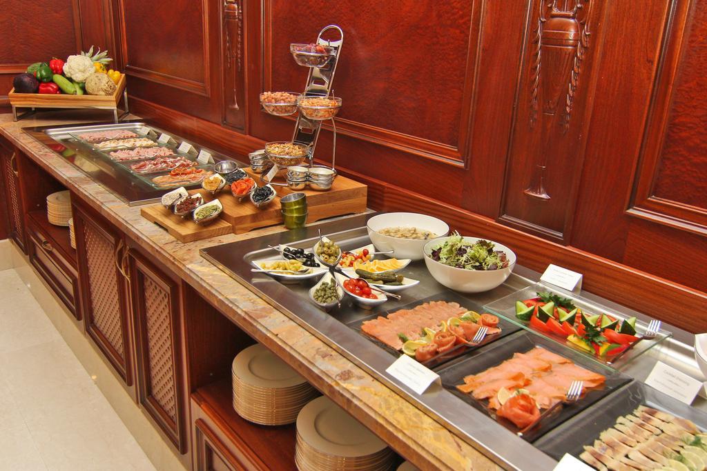 Orion Hotel Bisjkek Buitenkant foto A buffet