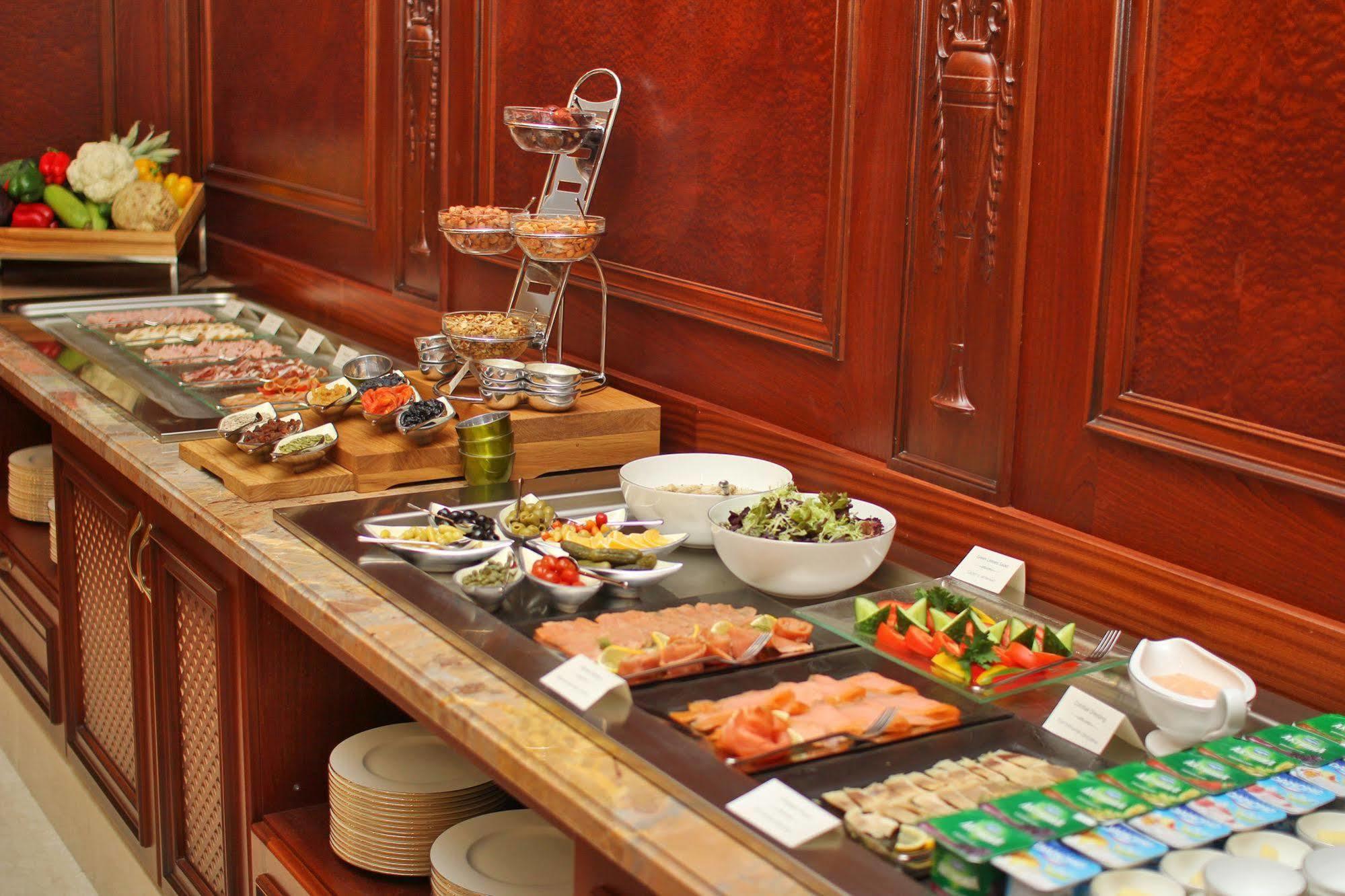 Orion Hotel Bisjkek Buitenkant foto A buffet at a hotel